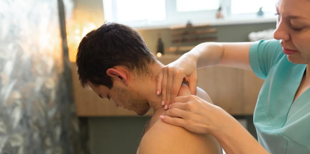 Therapist treating neck and shoulder muscles with hands-on techniques