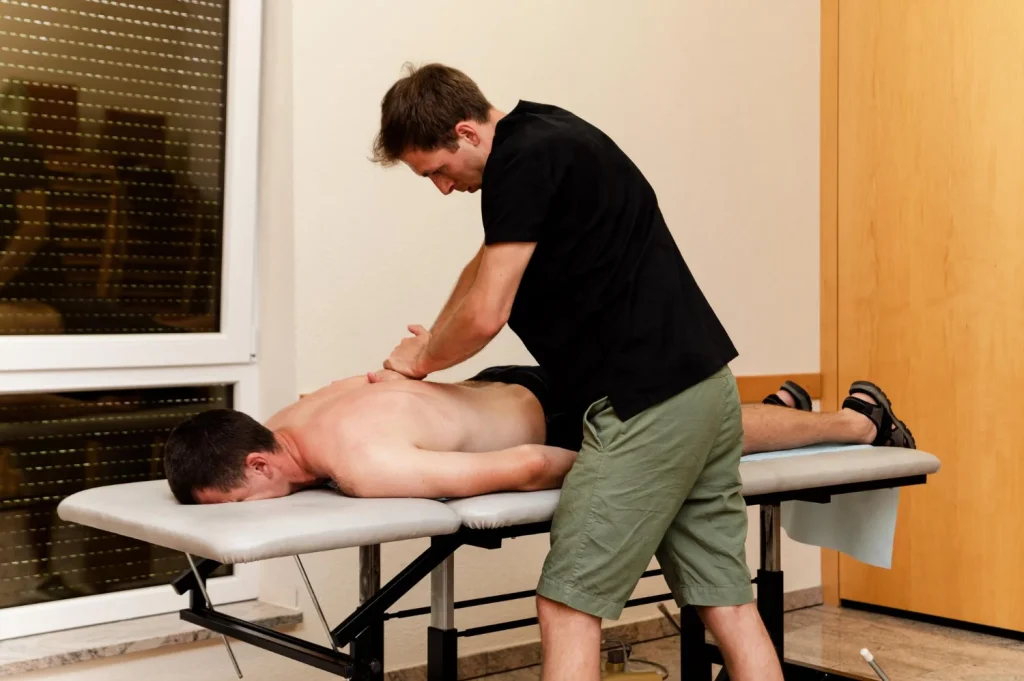 Therapist using hands-on sports massage techniques on a client's leg