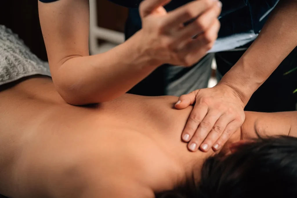 Therapist performing a deep tissue massage on the back